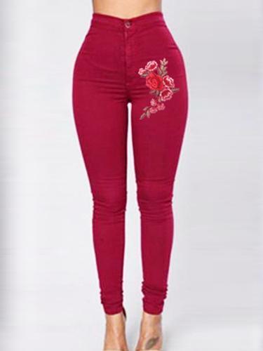 Jeans magri da ricamo floreale rosso